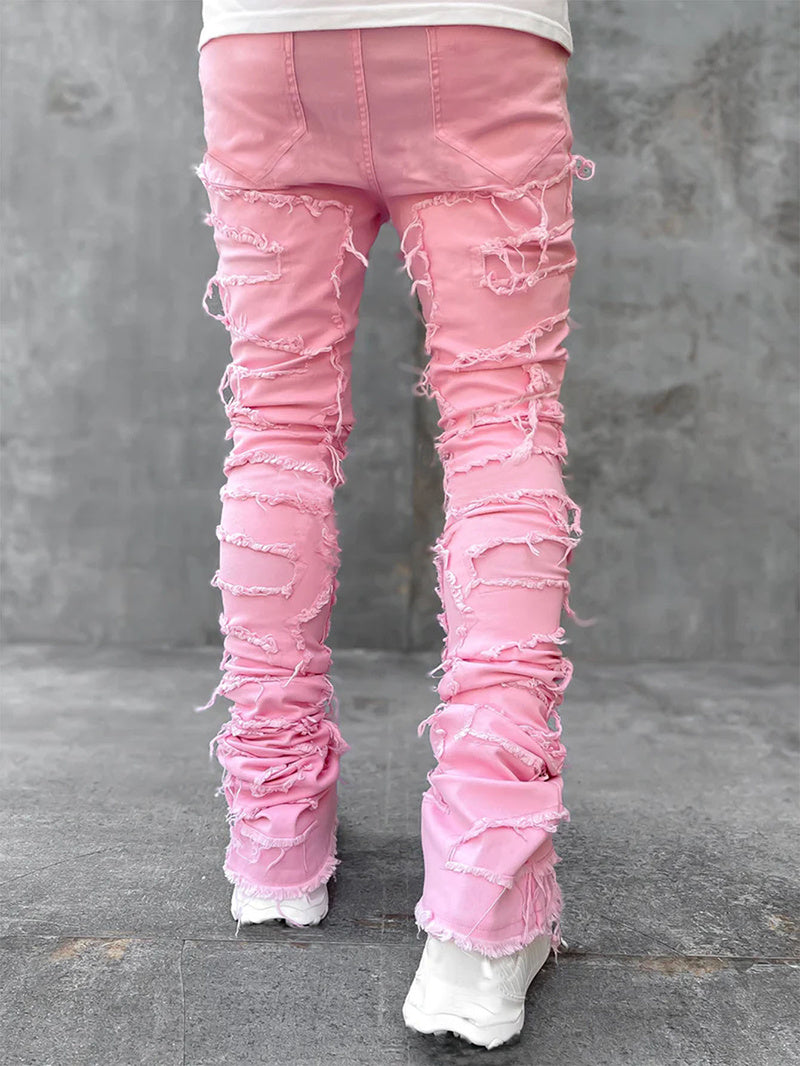 Distressed stacked jeans detail shot
